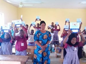 Recipients of our Notebooks Supply Program excitedly display their notebooks. 2