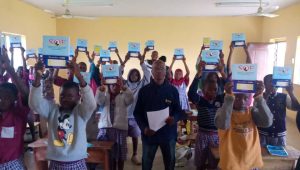 Recipients of our Notebooks Supply Program excitedly display their notebooks. 1